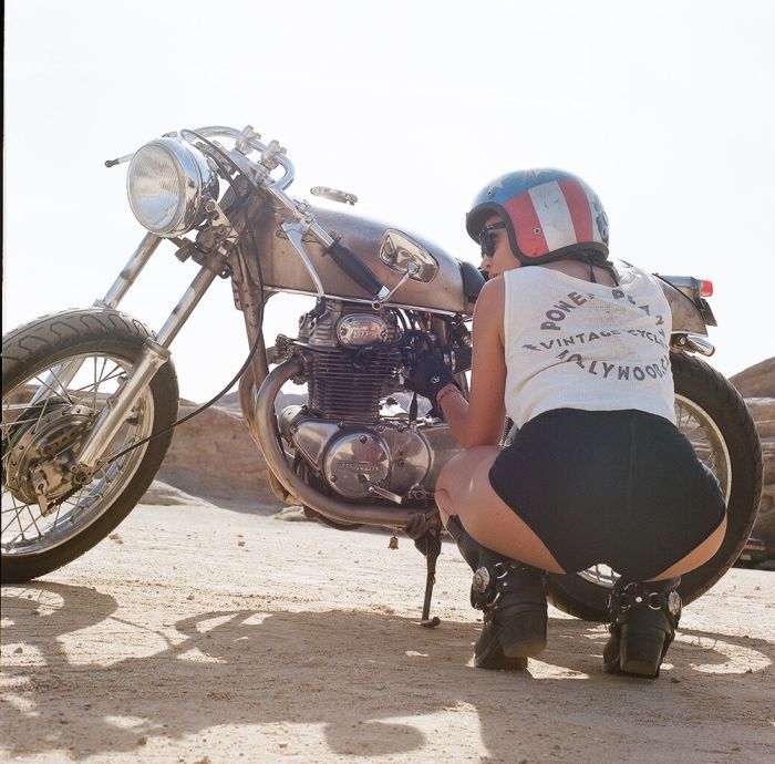 A playful frame from Girls on a motorcycle — online in Paris
